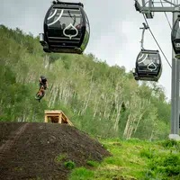 Biker under the Snowmass Gondola in the bike park 