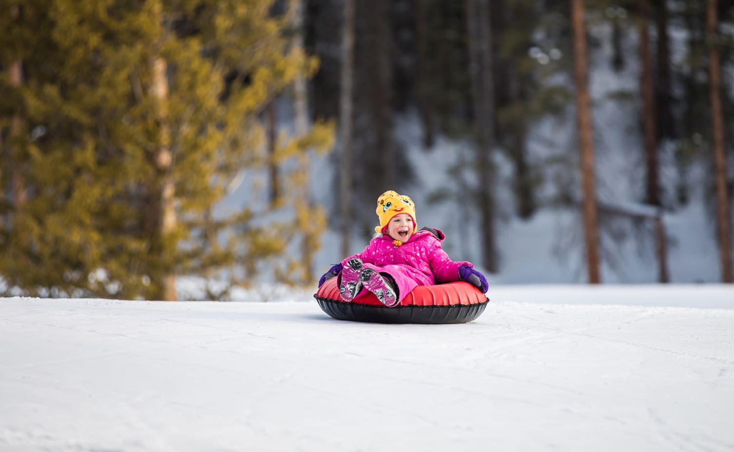 Child having a blast while tubing at Snowmass
